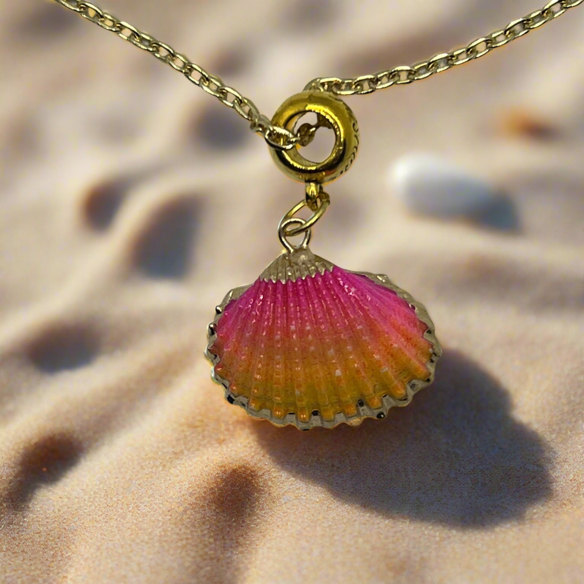 pink, orange, and gold painted seashell 