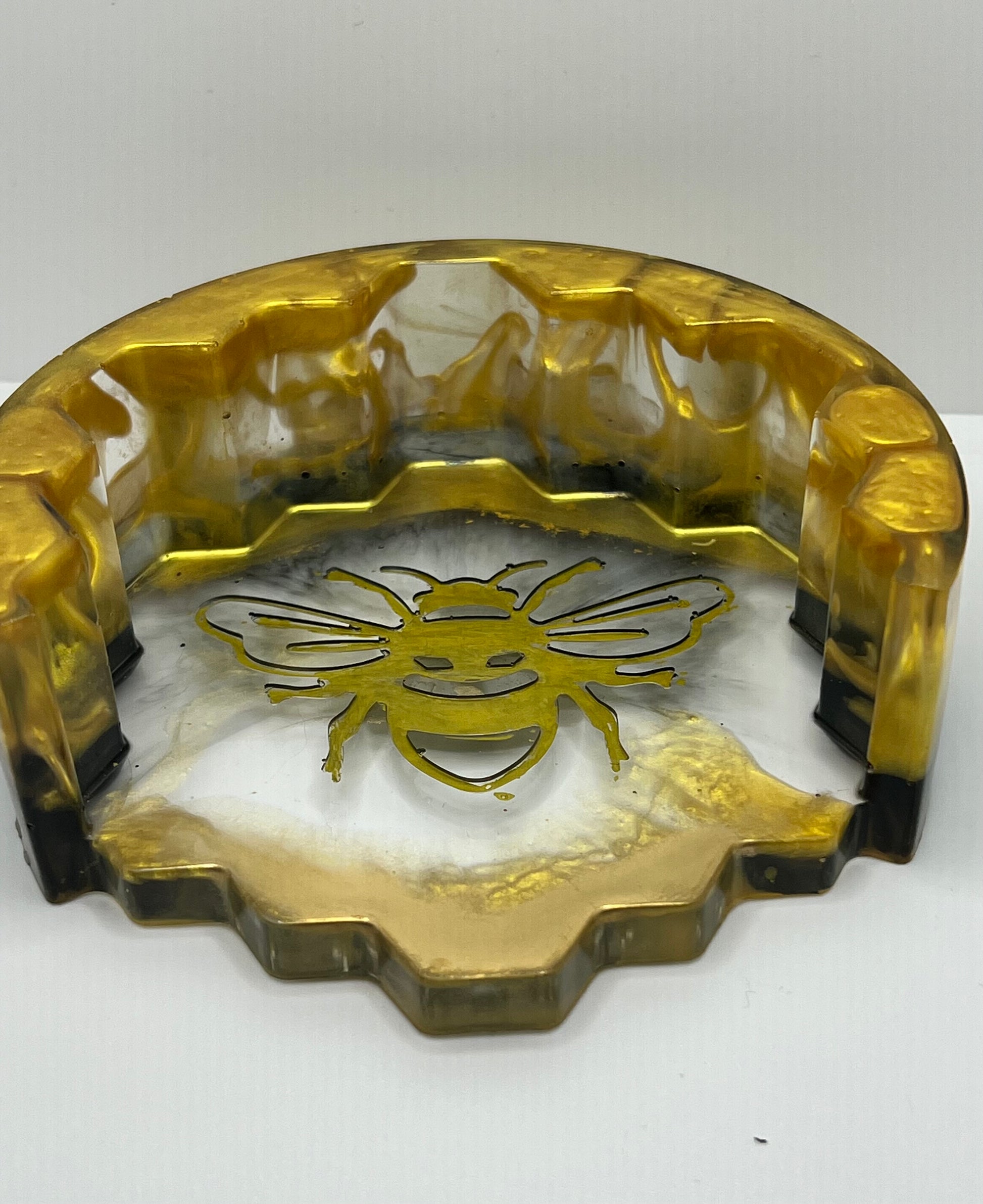 gold and black coaster holder with gold bumblebee